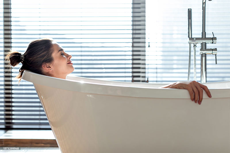 Woman relaxing in bathtub